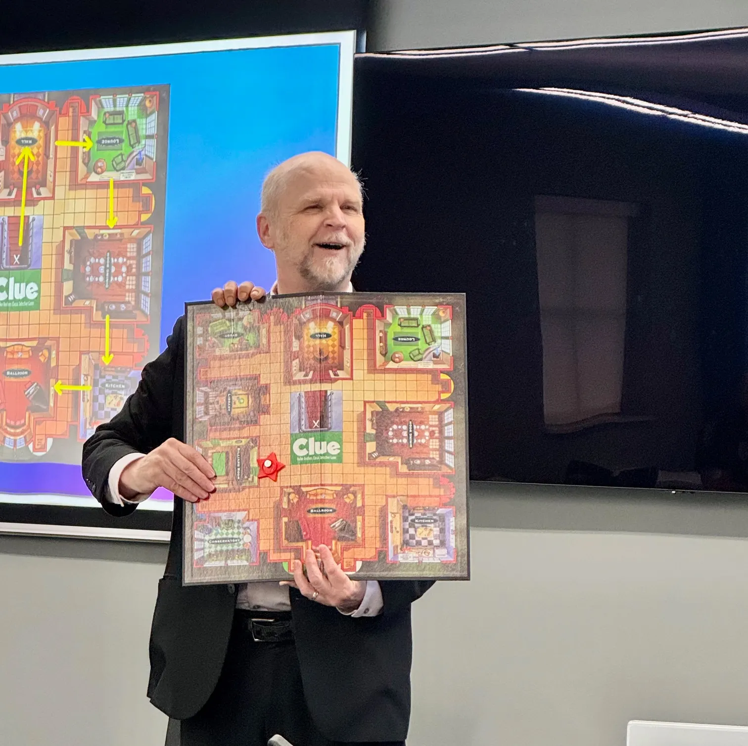 3 hands holding a Clue board