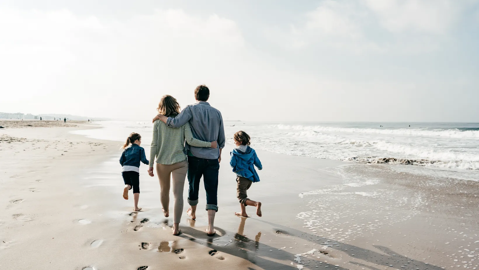 family walking at the beach