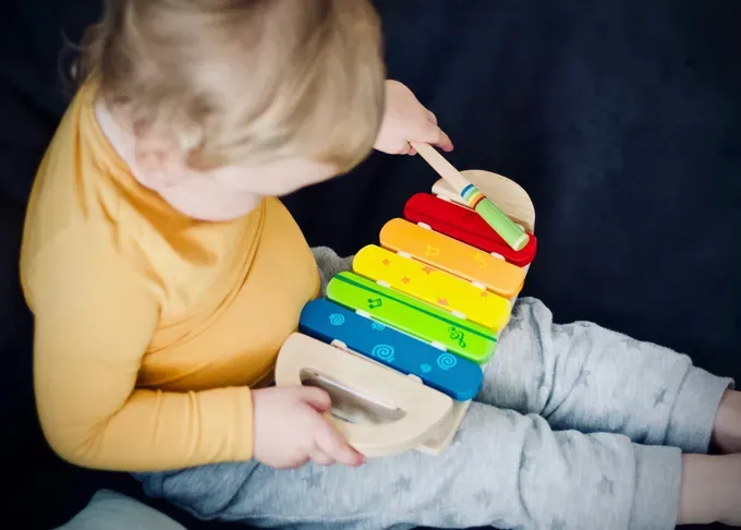 little boy learning musical instrument