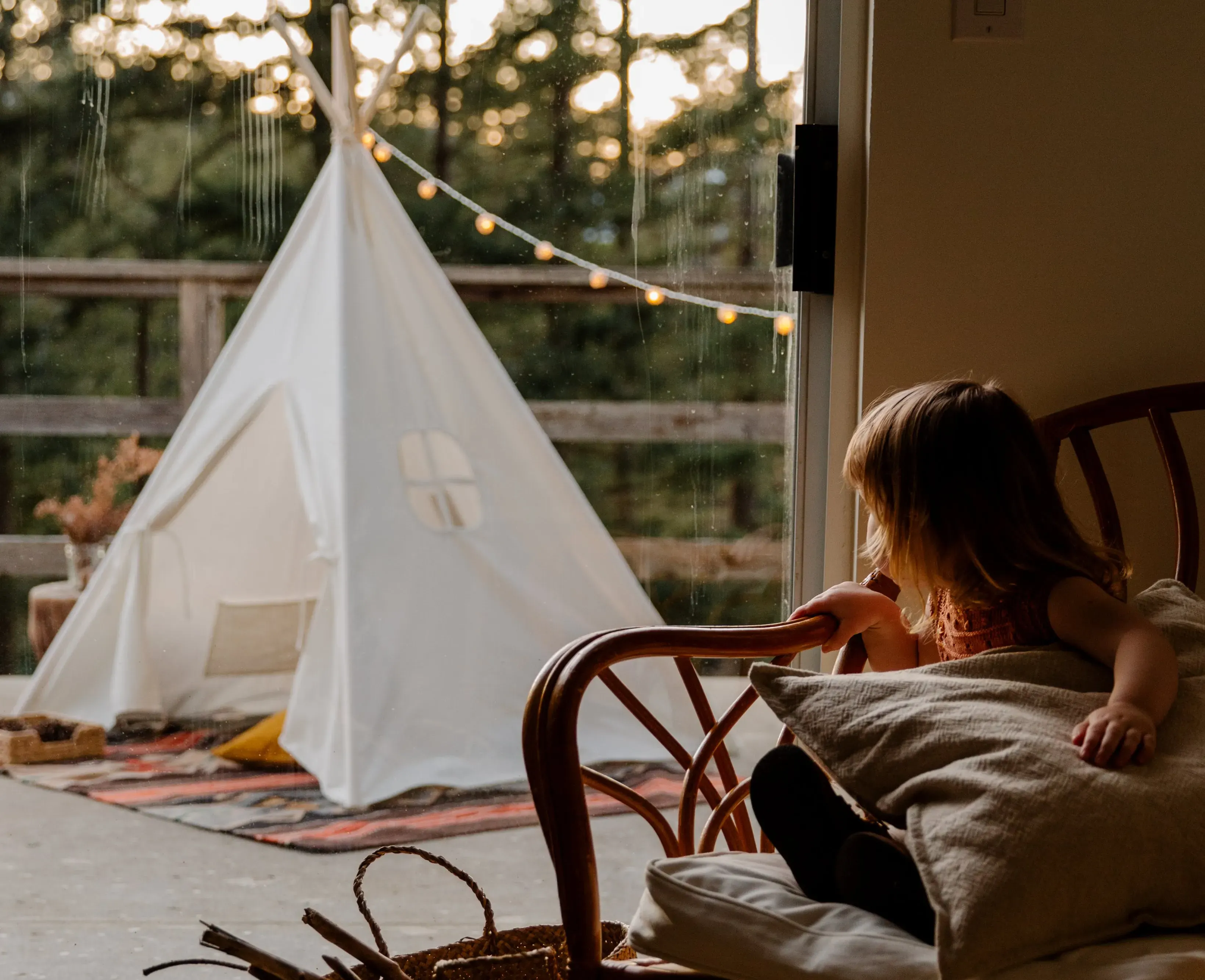 girl looking outside at TeePee Tent