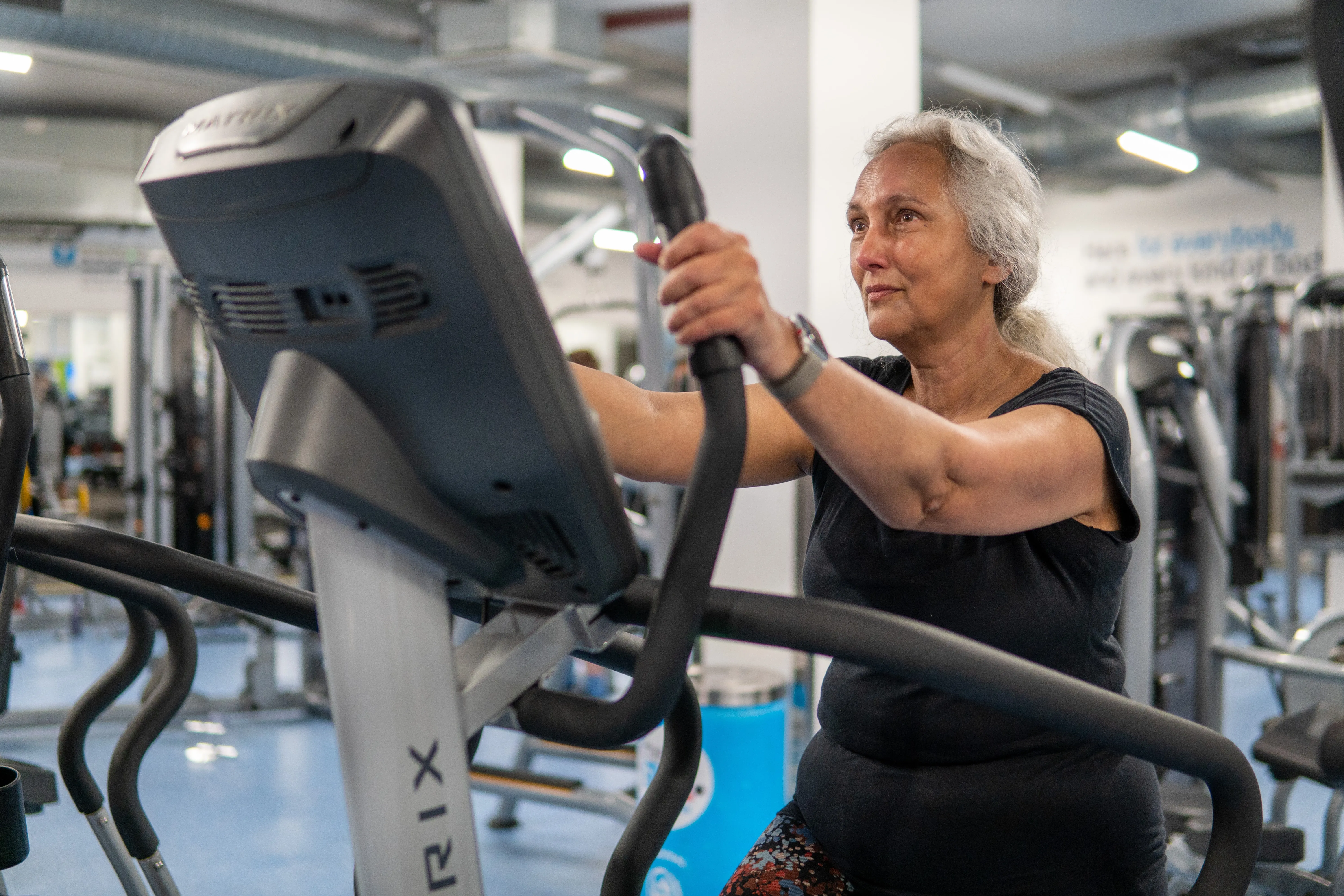 Elder lady on gym machine