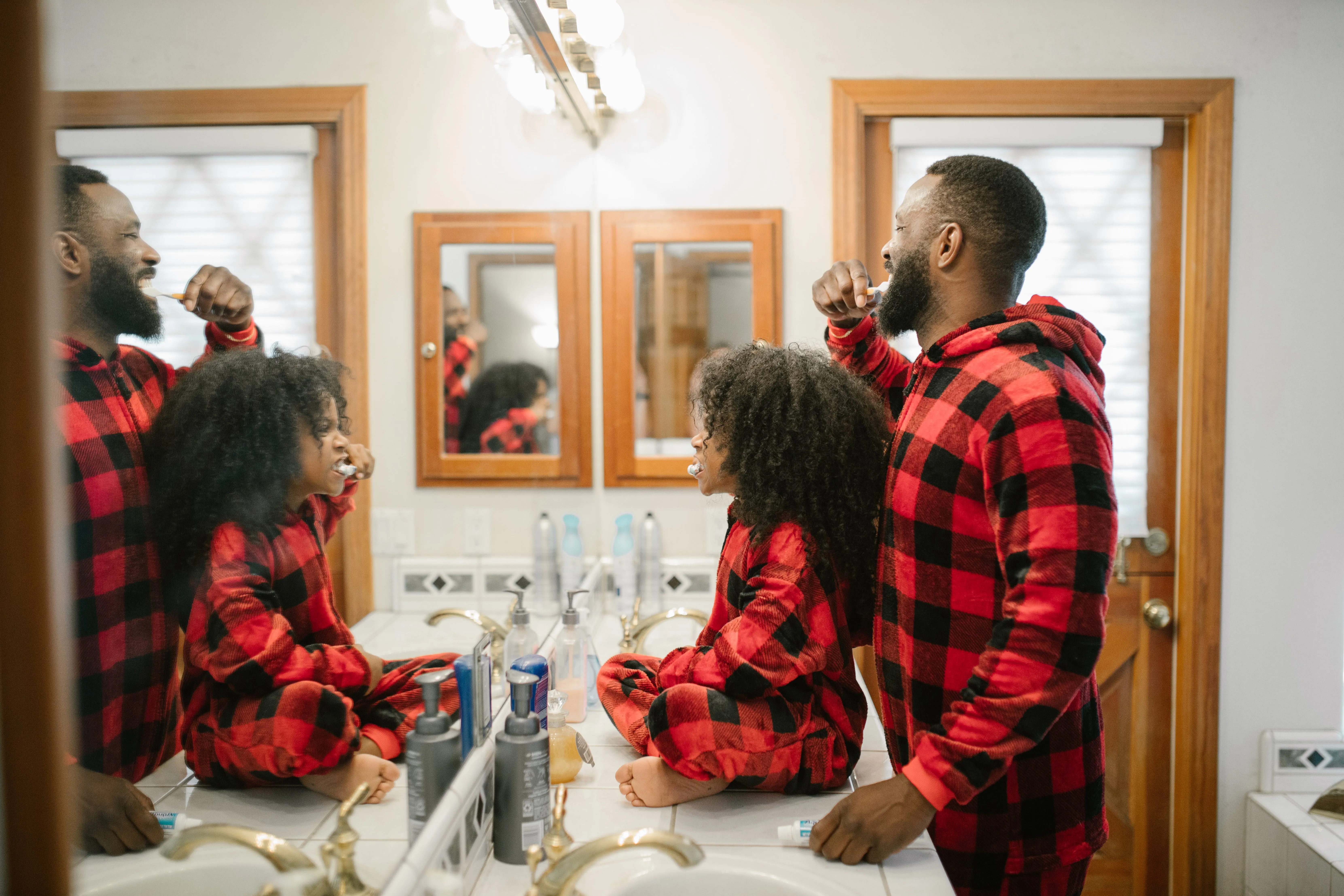 Dad and daughter brushing teeth