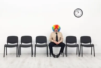 a male job candidate sitting alone in a waiting room