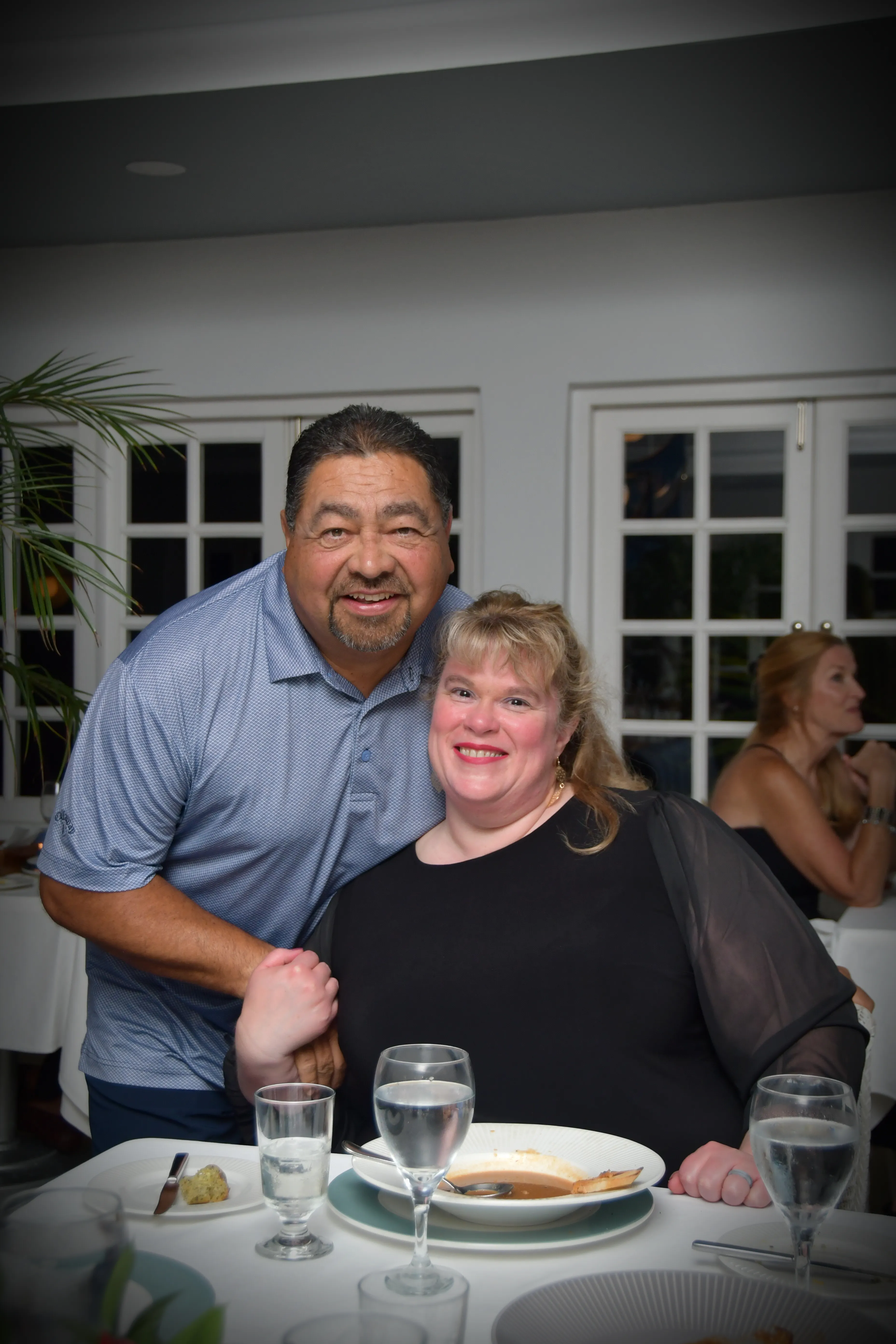 Dr Melissa Balizan and husband in kitchen with windows in the background