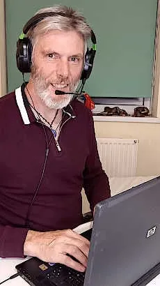 man using headset and computer