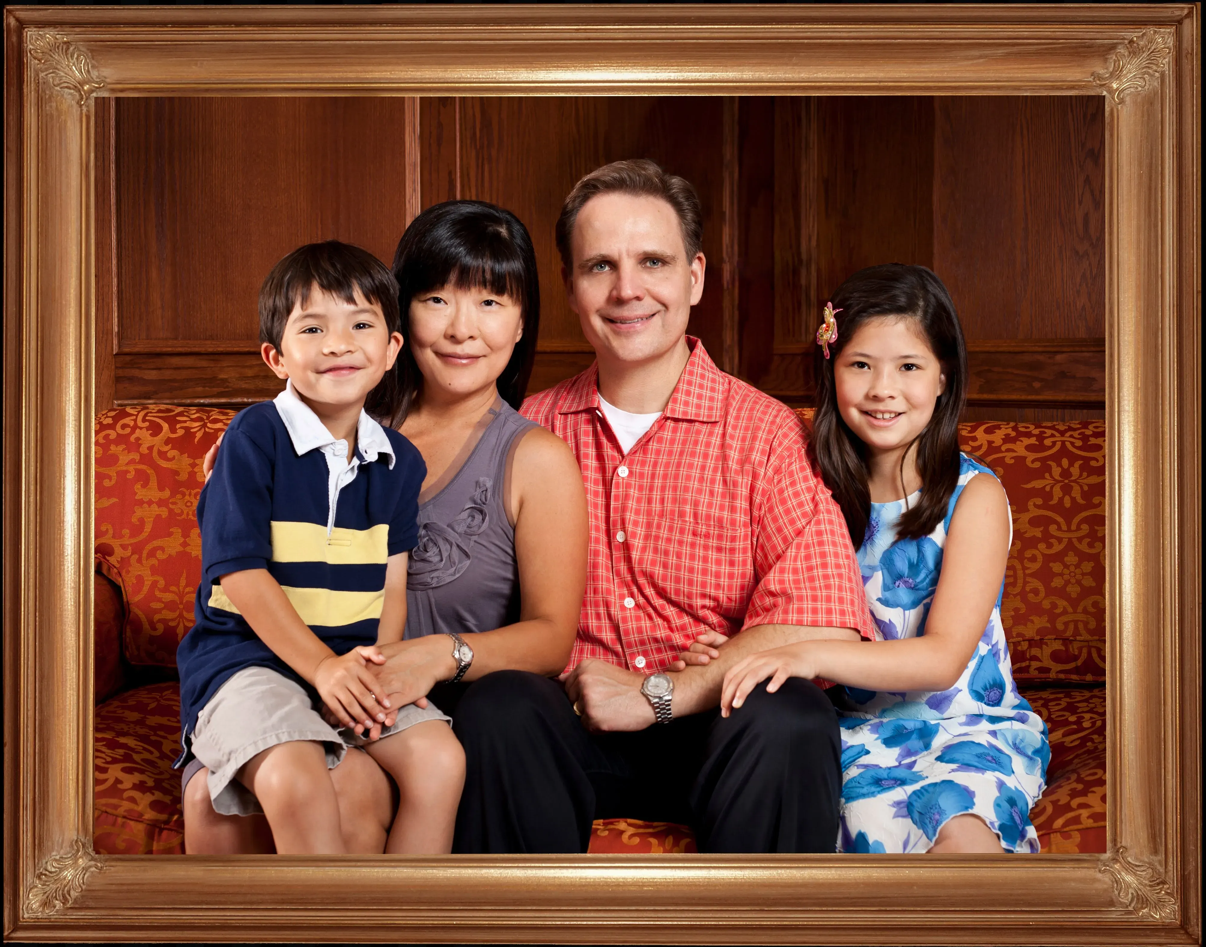 Waggoner Family Mom and Dad together, with a child on either side of them. Framed in a museum quality frame.