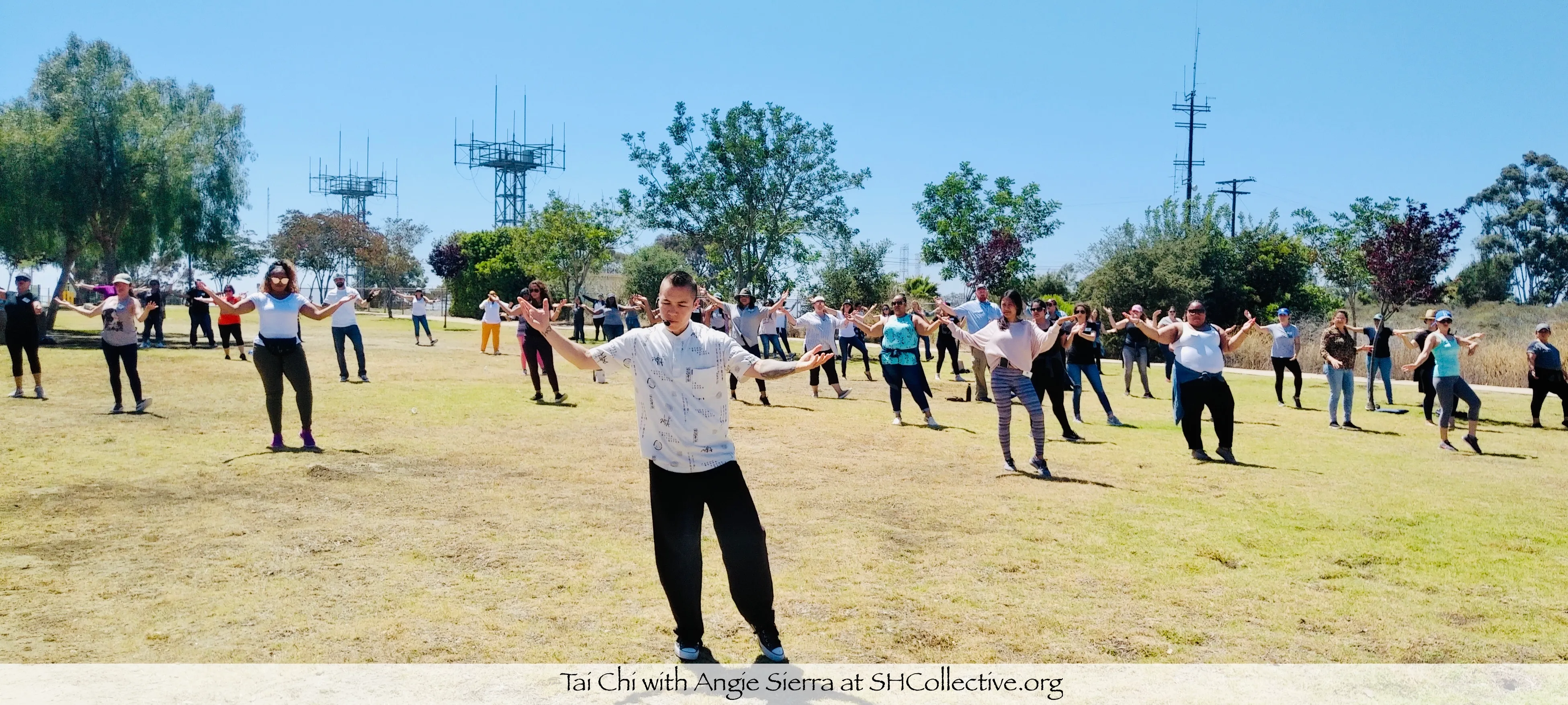 tai chi class in a spacious outdoor field with an average of 50 participants
