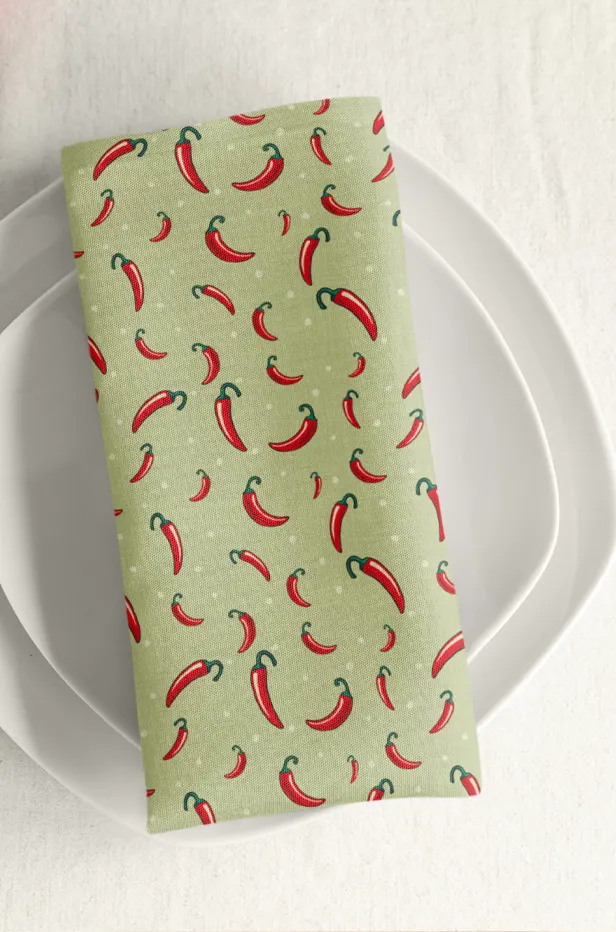 chili pepper napkins laying on plate