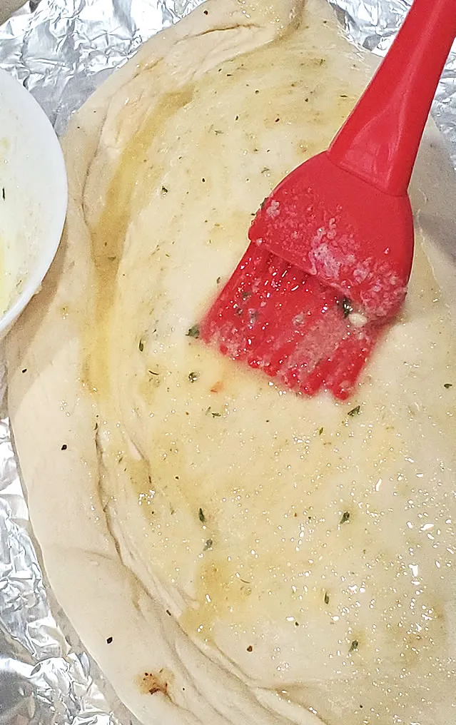 Spread Melted Butter With Garlic Powder On Your Calzone