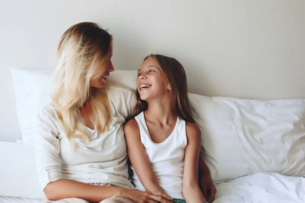 Mom and her daughter laughing together.