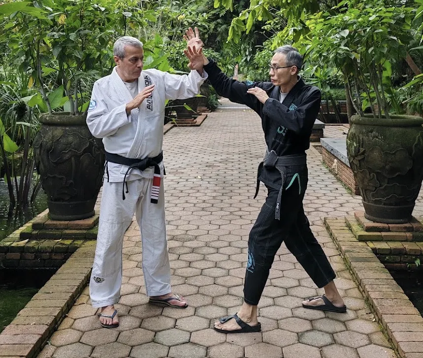 Leon Koh and Avi Nardia demonstrating martial arts techniques during a KAPAP Krav Maga technical training session.