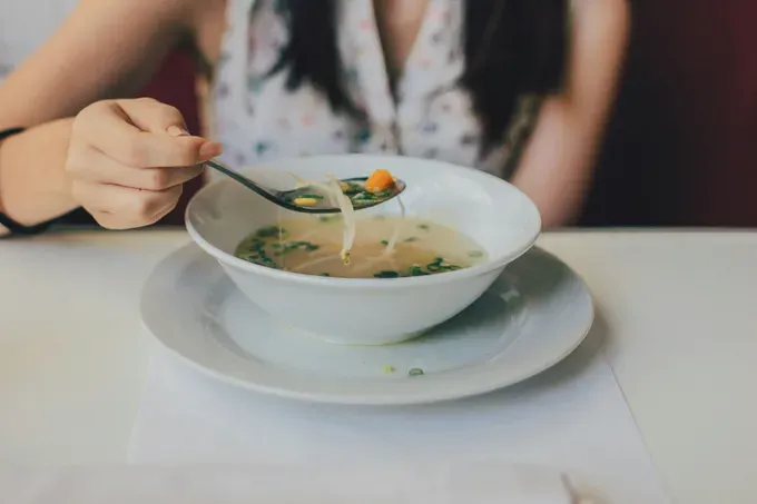 Happy pregnant woman eating her lunch