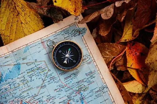 compass facing placed on a map facing north