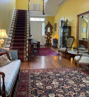 Entry hall of The Essex Inn in Tappahannock Virginia, utilizing period furnishings and paint color in the restoration