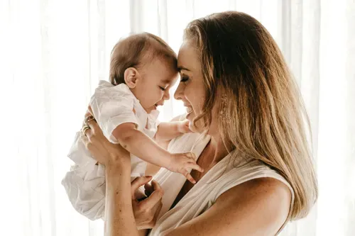 baby playing with her mom