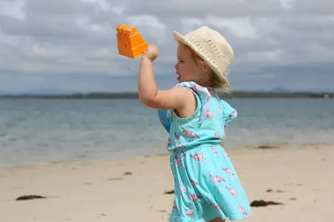 little girl playing on the beach