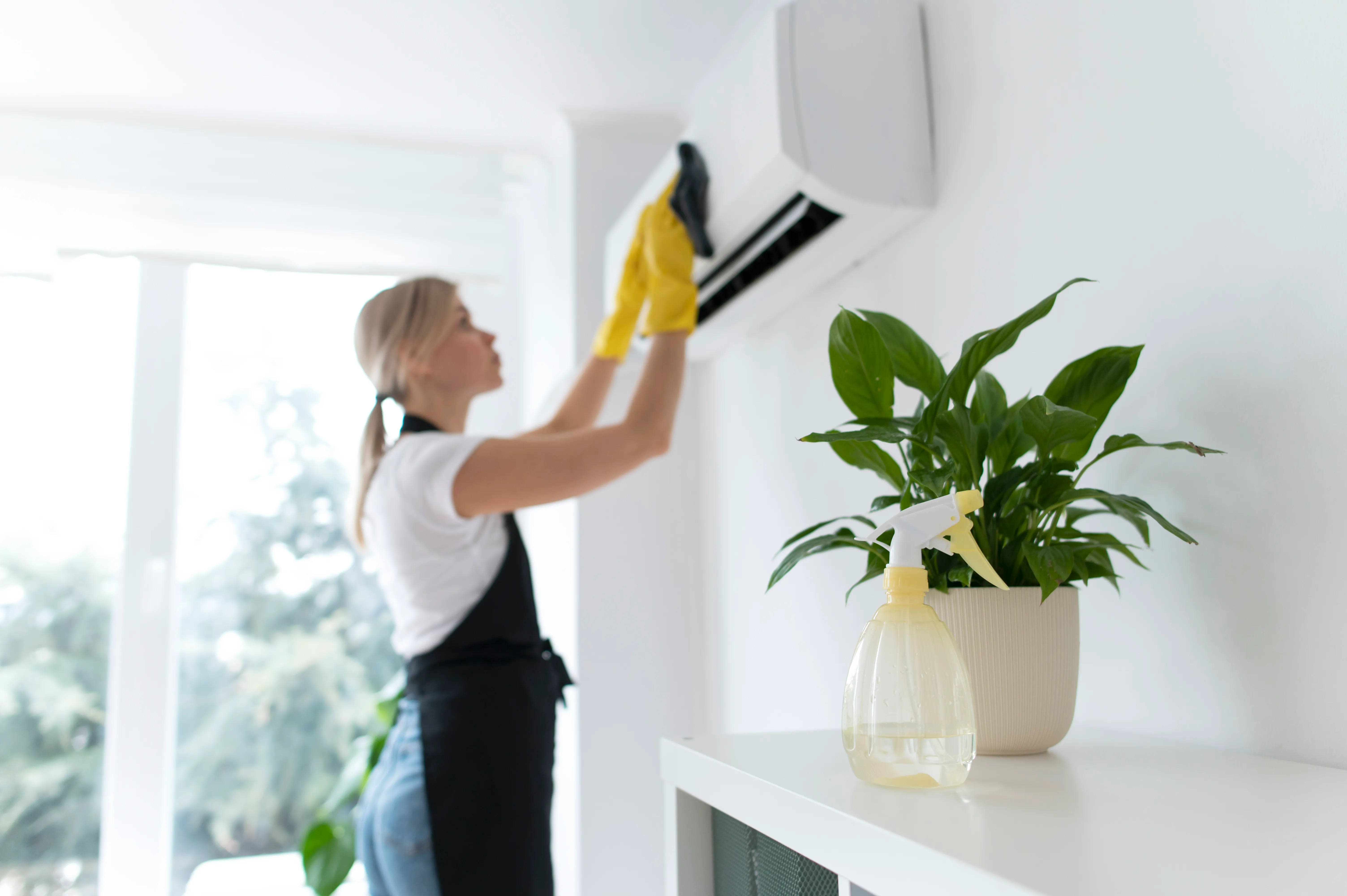 staff-member-cleaning-air-conditioner