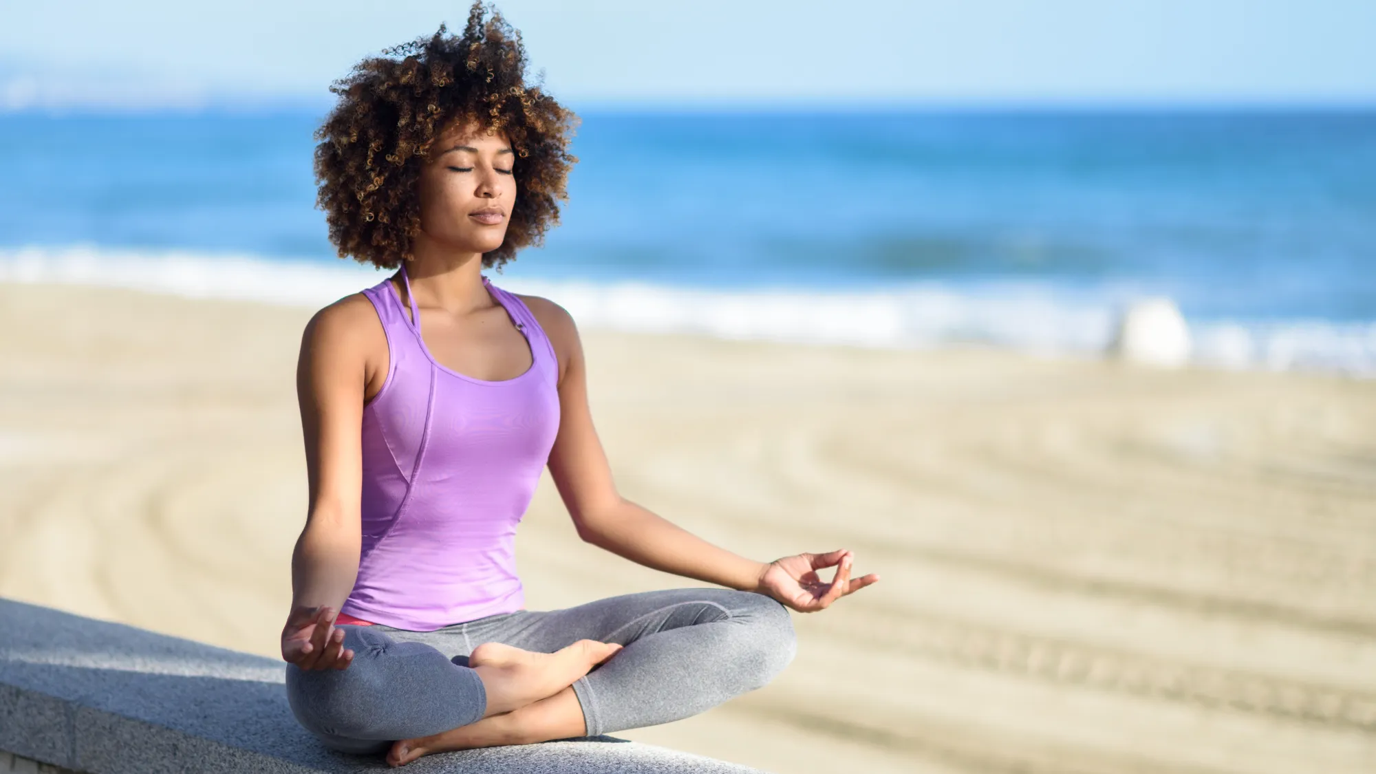 woman in lotus pose promoting calmness and relieving anxiety
