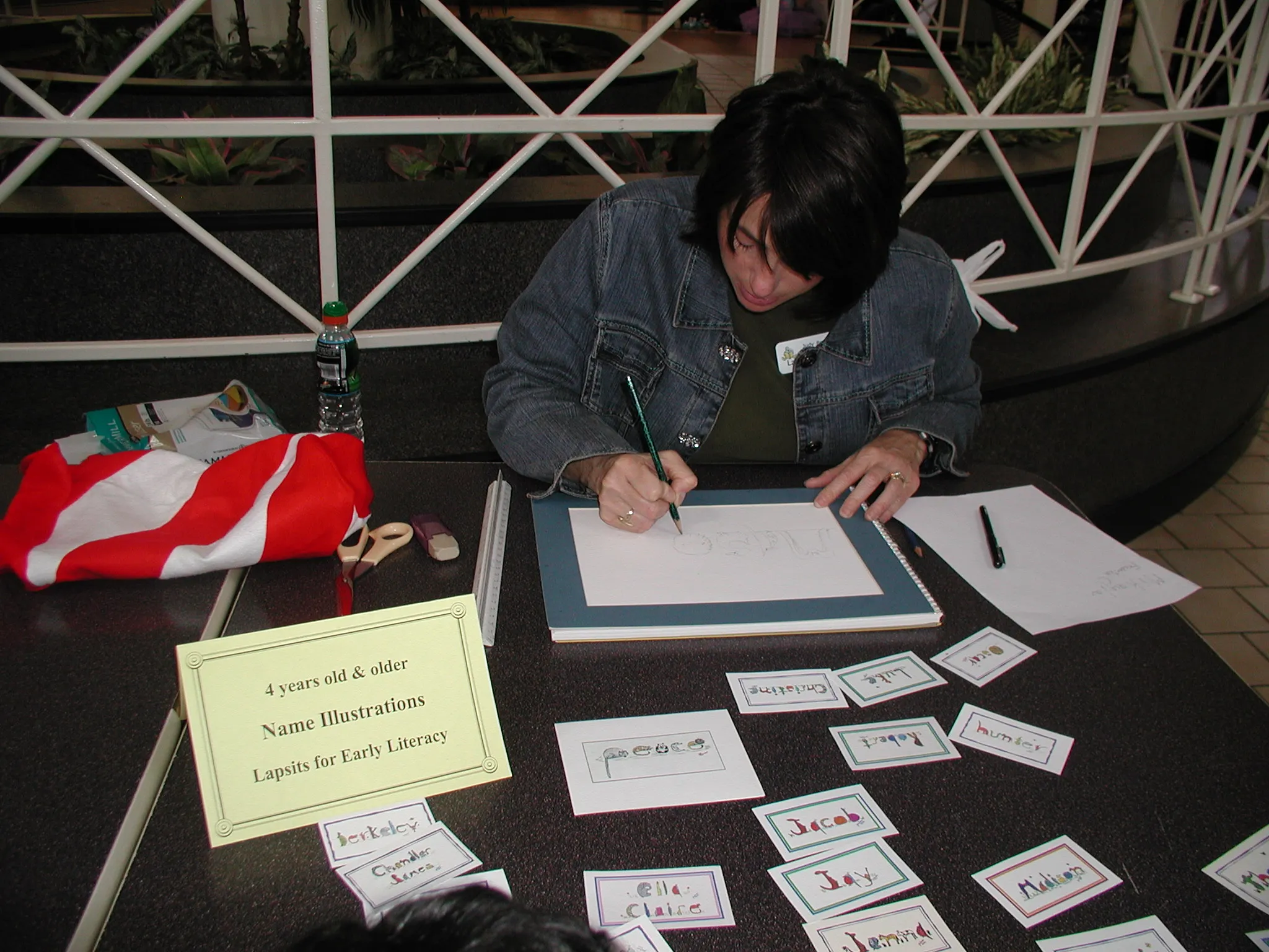 Artist, Judy Benedict, drawing animal name pictures at a literacy event in Greenville SC