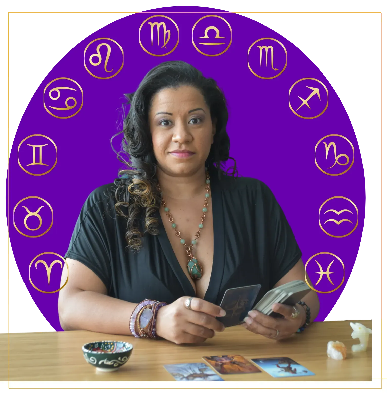 Mel Morris owner of This is What’s Next surrounded by astrology symbols holding tarot cards