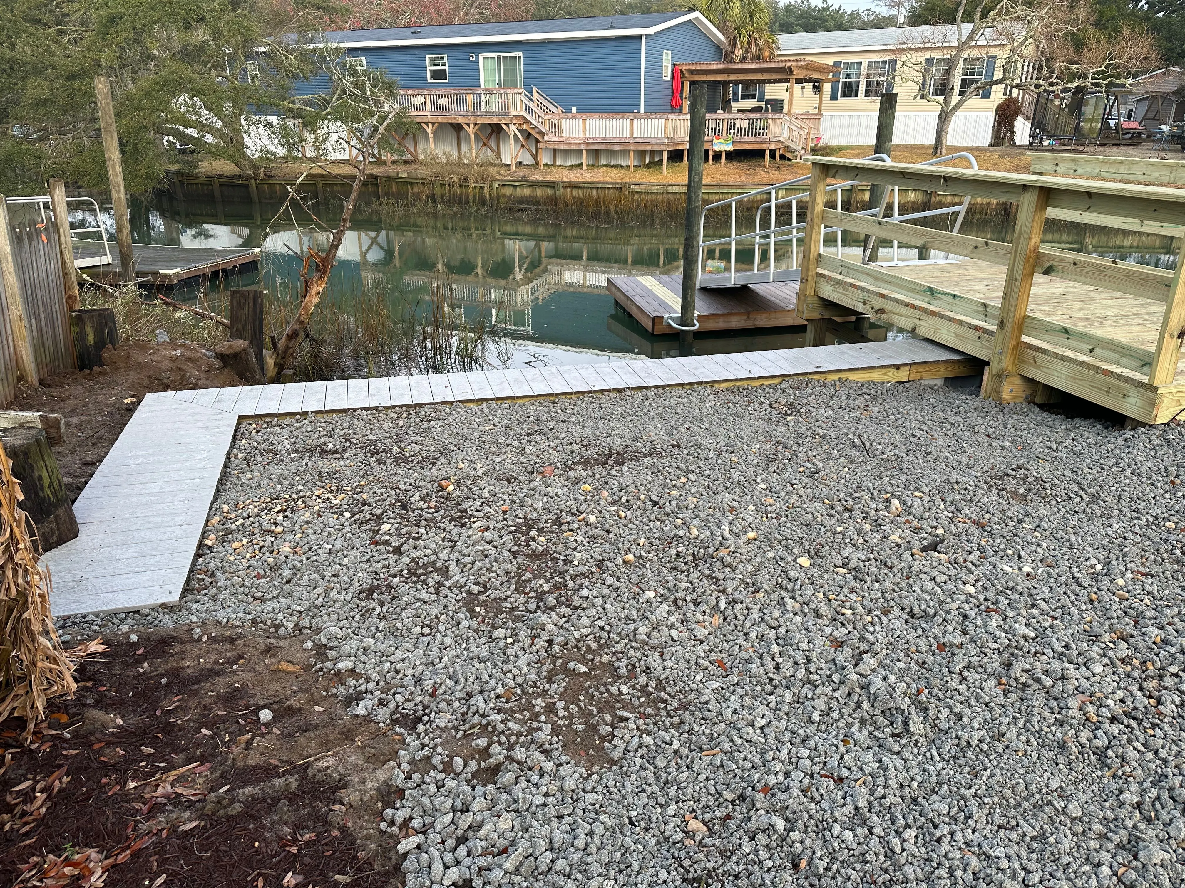 Vinyl Bulkhead with composite wood cap in Murrells Inlet SC on a salt water creek built by Waterbridge Contractors of the Carolinas