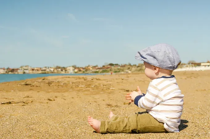 baby sitting alone in the beach