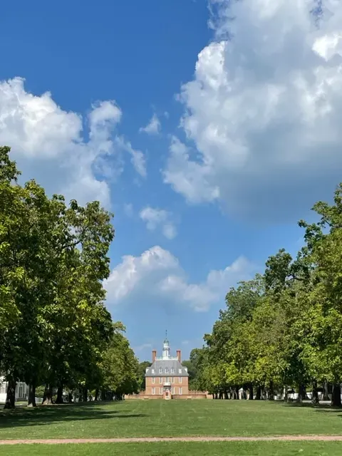 Catalpa trees lining the Palace Green with a view of the Governor's Palace in Colonial Williamsburg
