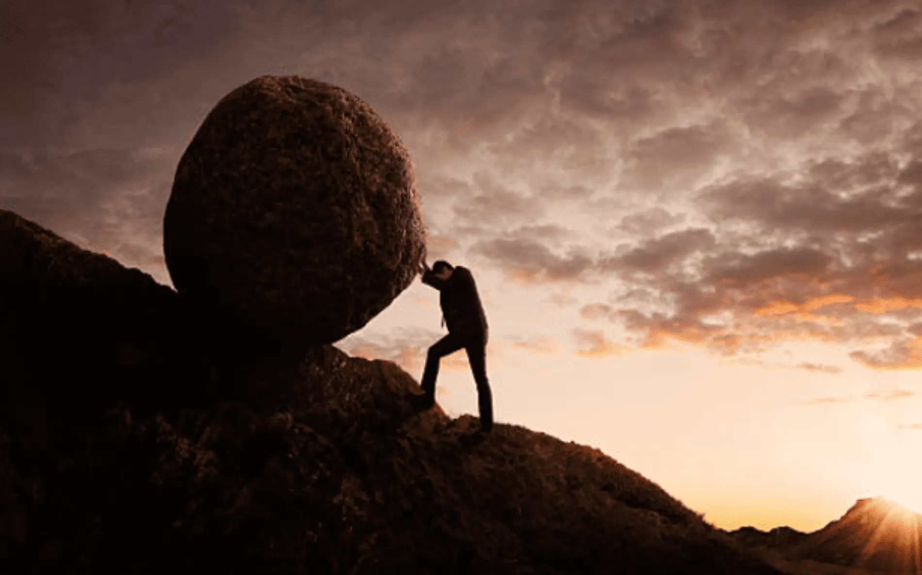 A person pushing a rock up hill