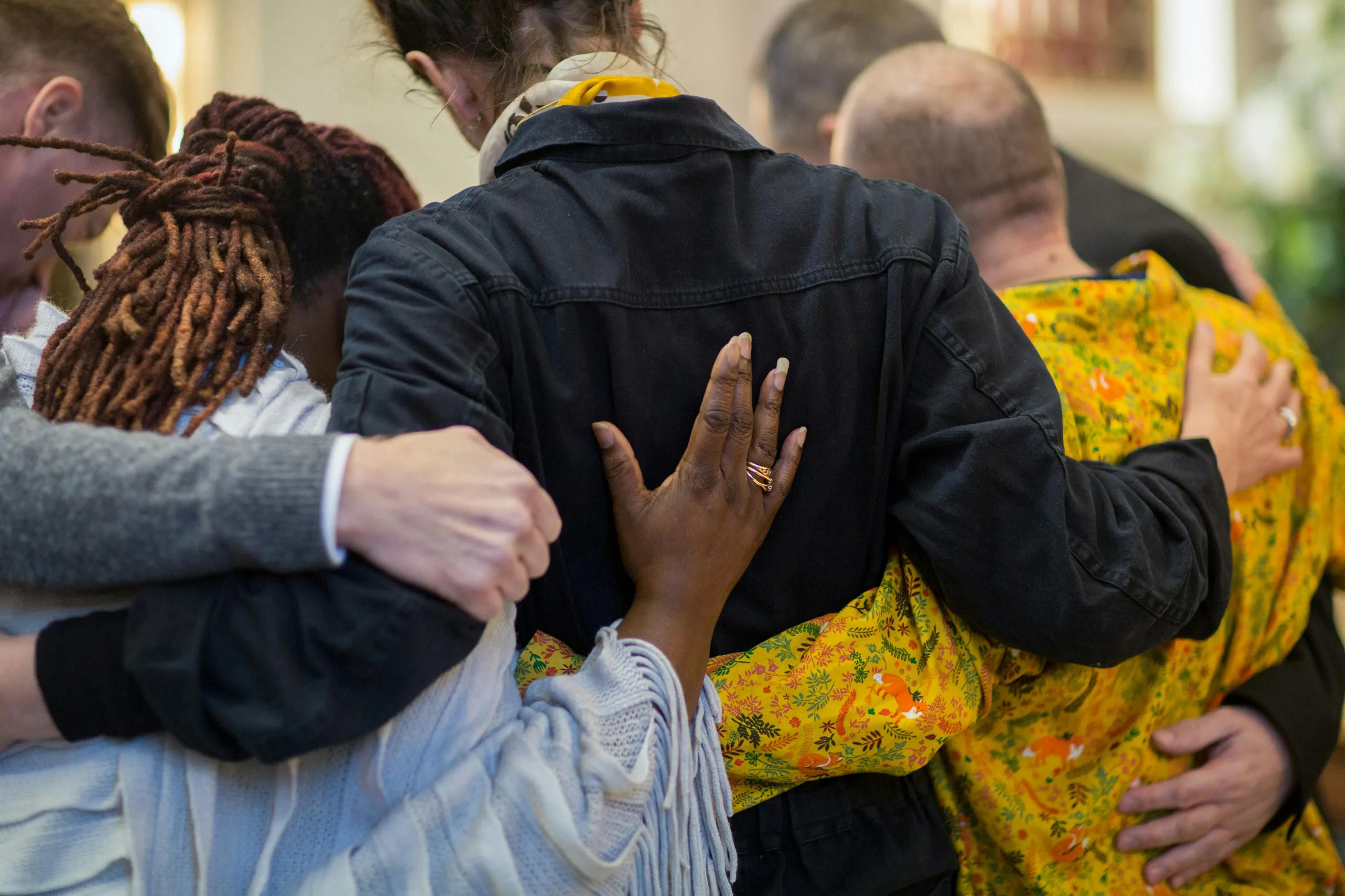 People hugging each other as they grieve.