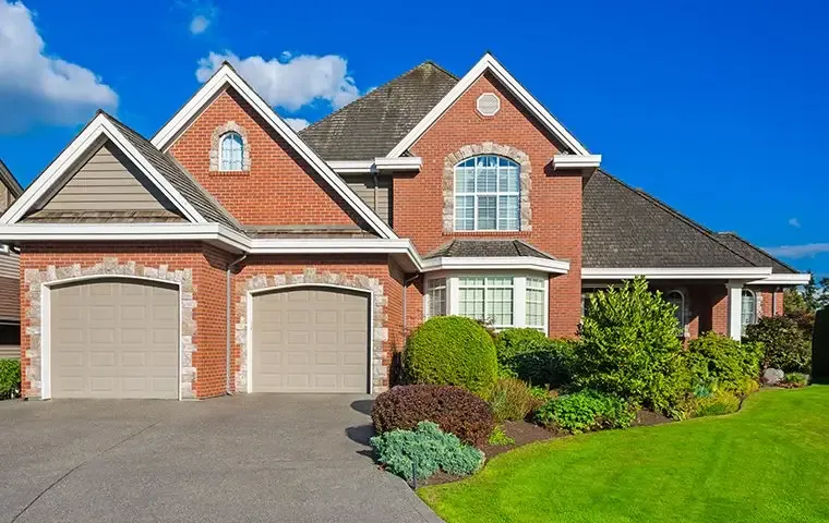 a brick two story house with attached garage