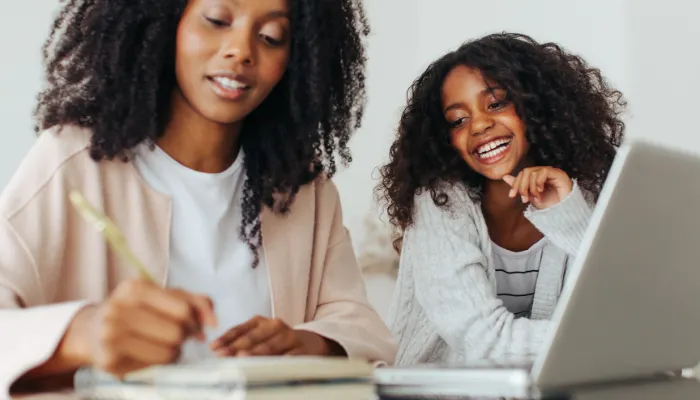 A mom and a daughter doing work together