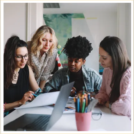 Small group of women learning together from documents on a table