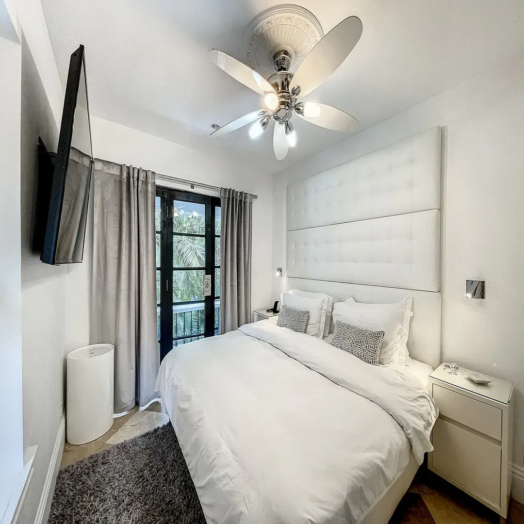 Second-floor bedroom at Villa Laurell Estate with private balcony and en-suite bathroom