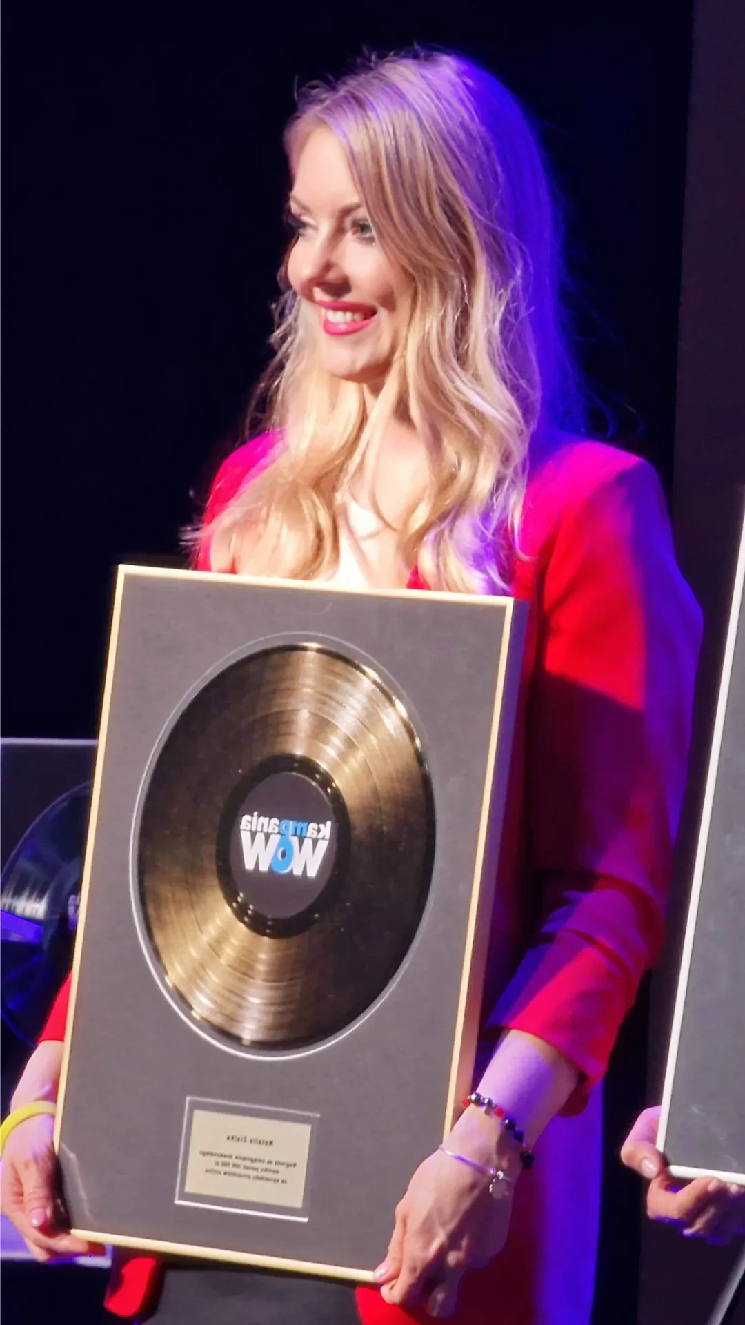 a woman holding an award for sale