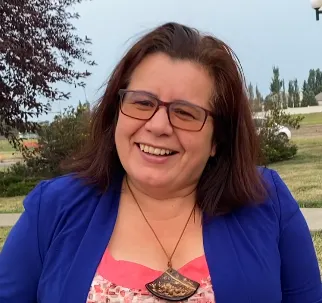 Photo of Sandra Cortes in a blue jacket and top 