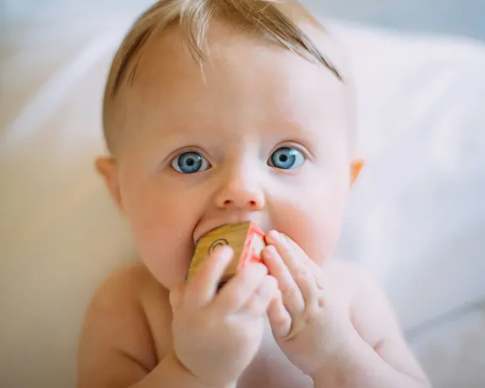 baby with cute blue eyes playing