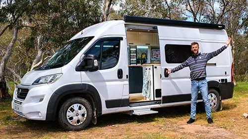 Matthew Storer standing beside his self-built camper van while travelling Australia full-time