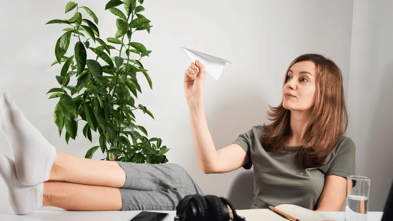 Woman Procrastinating flying paper airplane