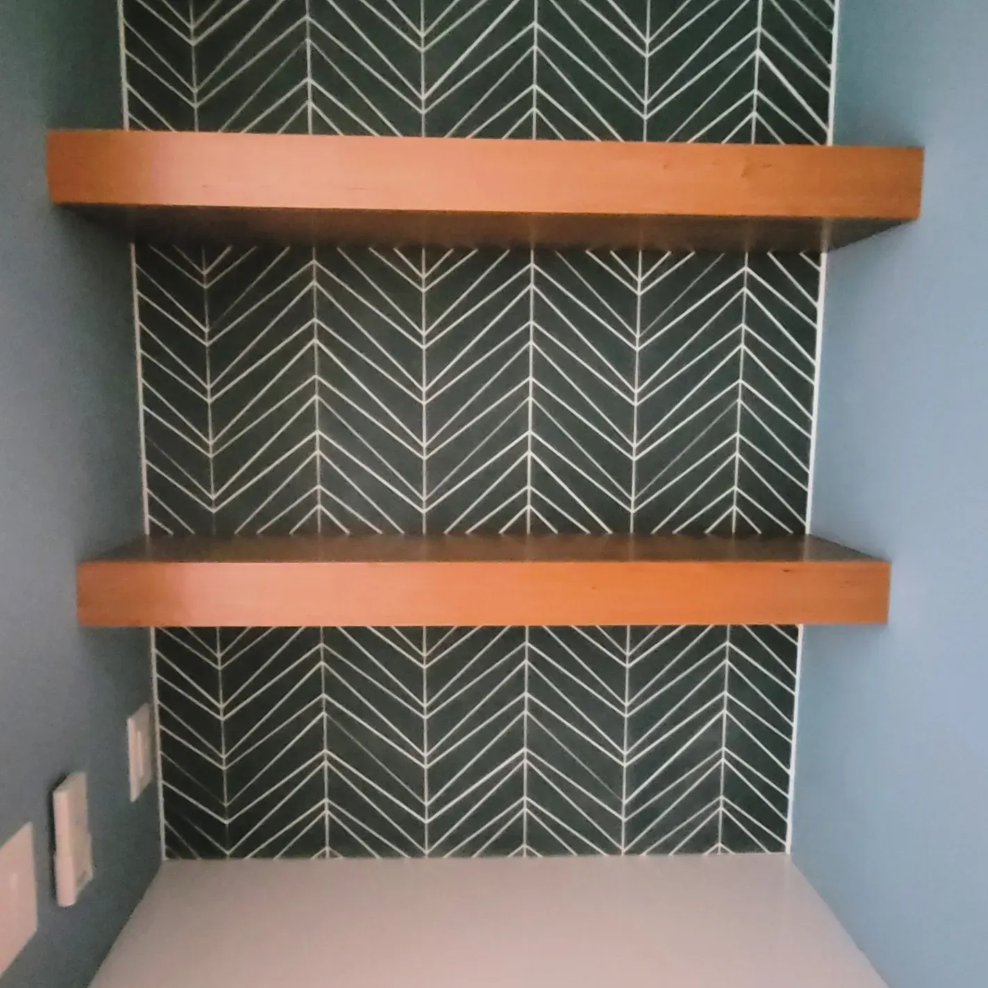 Custom shelves in a nook with a splash wall 