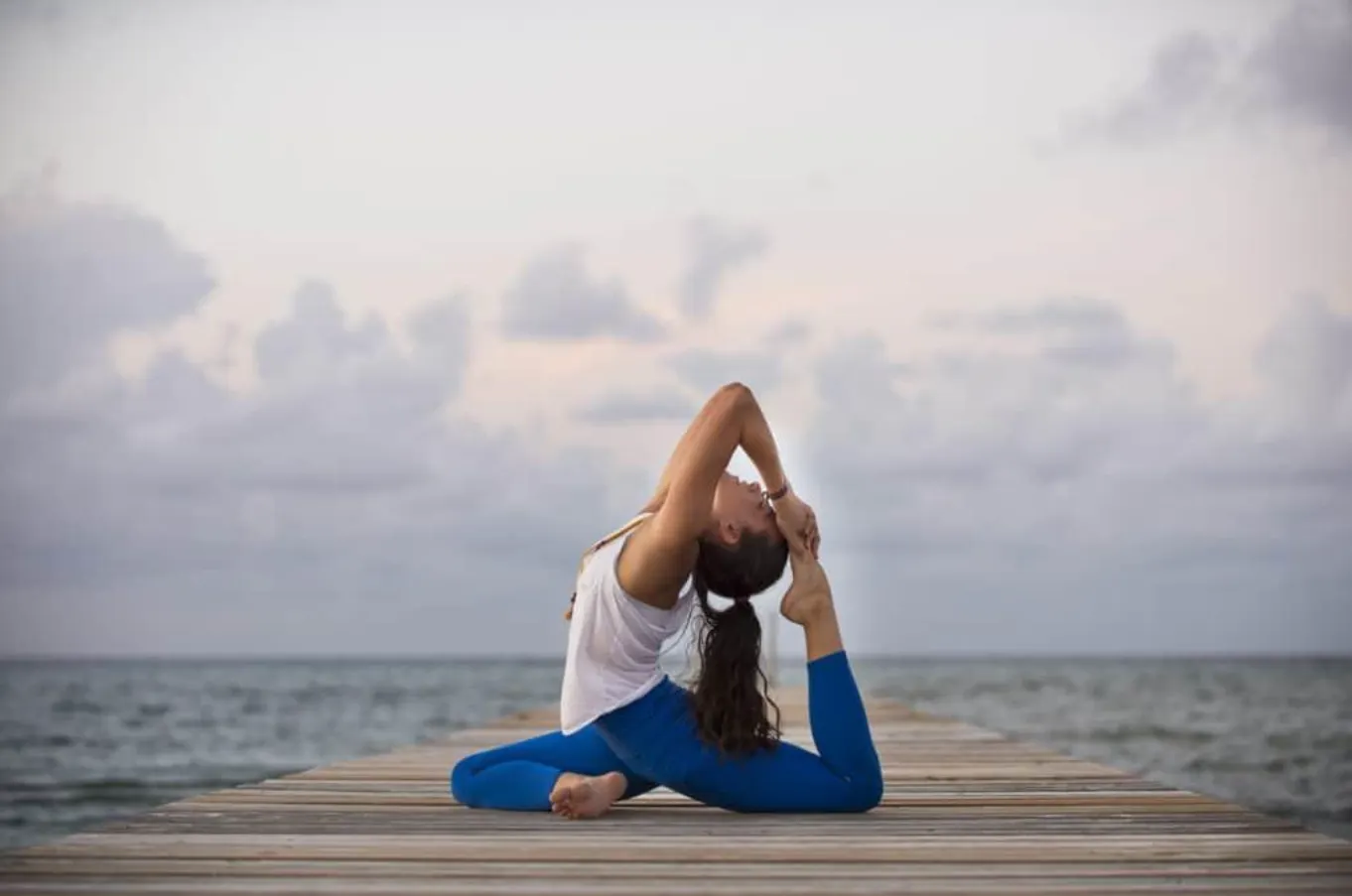 woman doing yoga at the beach