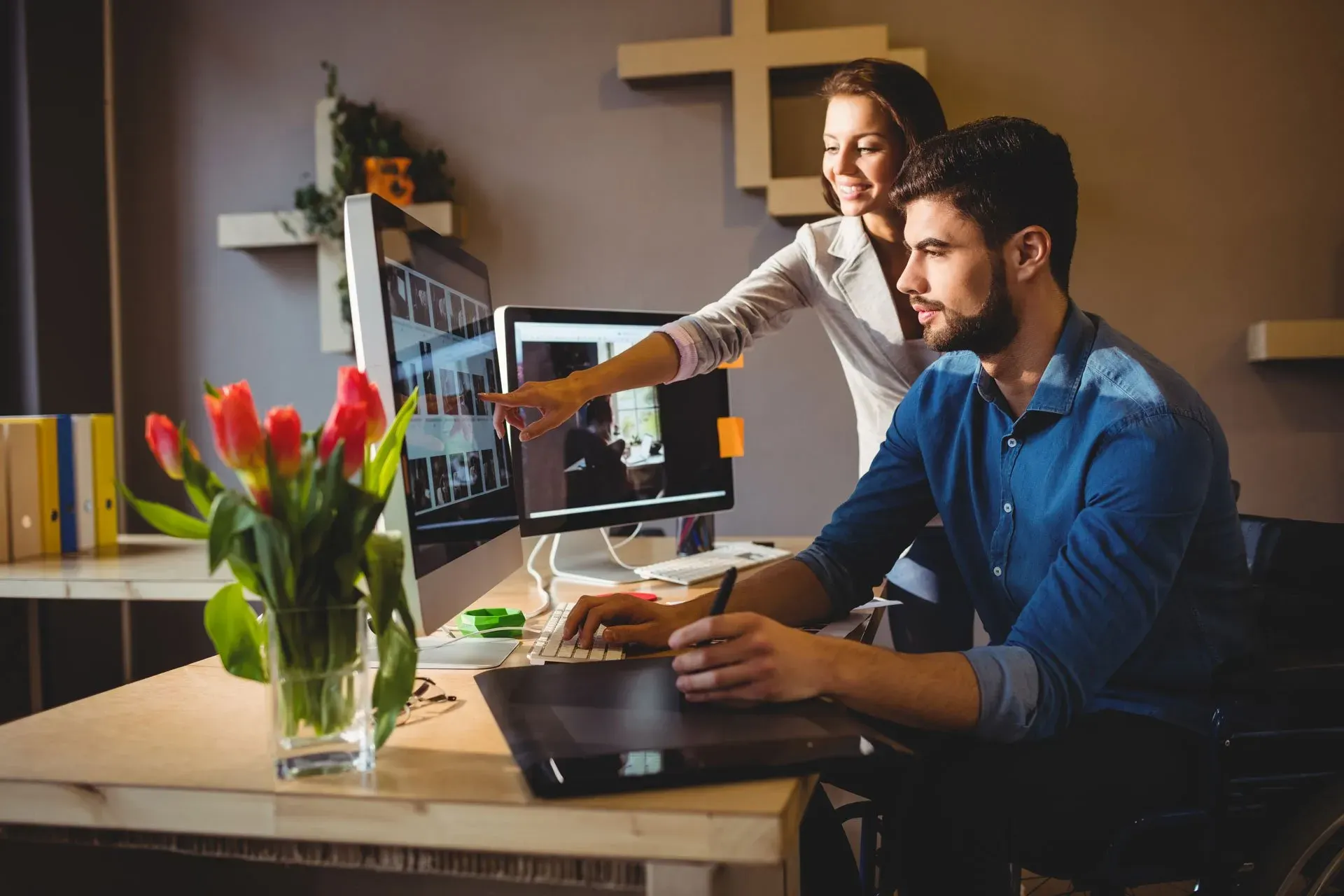 woman-showing-her-colleague-something-screen