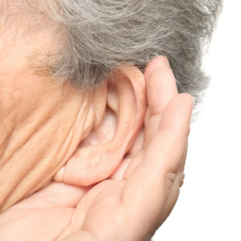 A close-up of a person's ear with gray hair, cupping their hand around their ear to enhance hearing. The background is minimalistic, and the word 'HEARING' is displayed in a bold, turquoise box at the top.