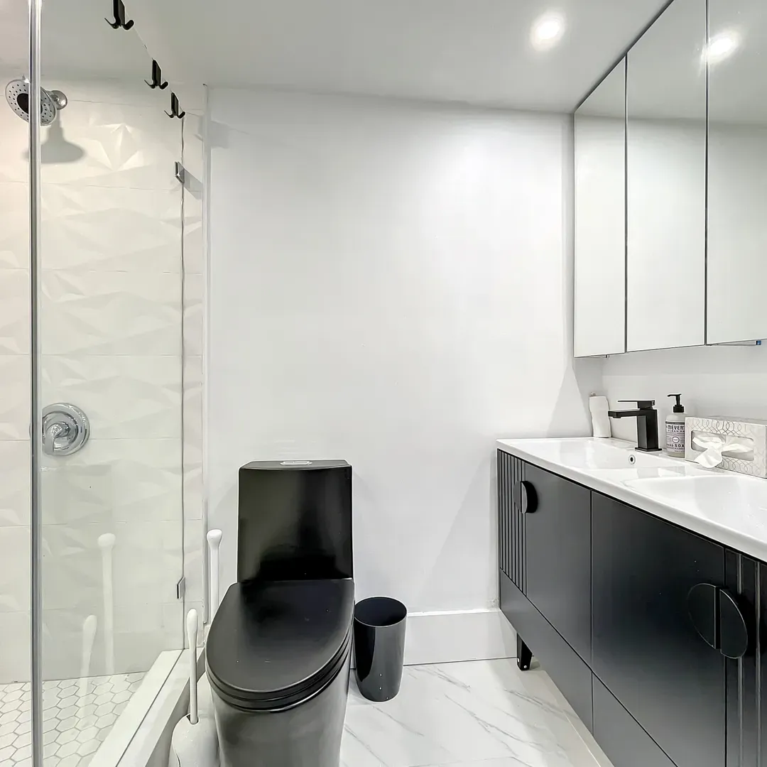 The second bathroom continues the spa-like atmosphere with custom amenities including dimmable vanity lighting to achieve your ideal brightness. 