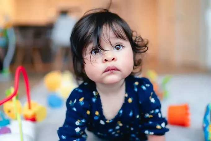 curious baby looking at her mom