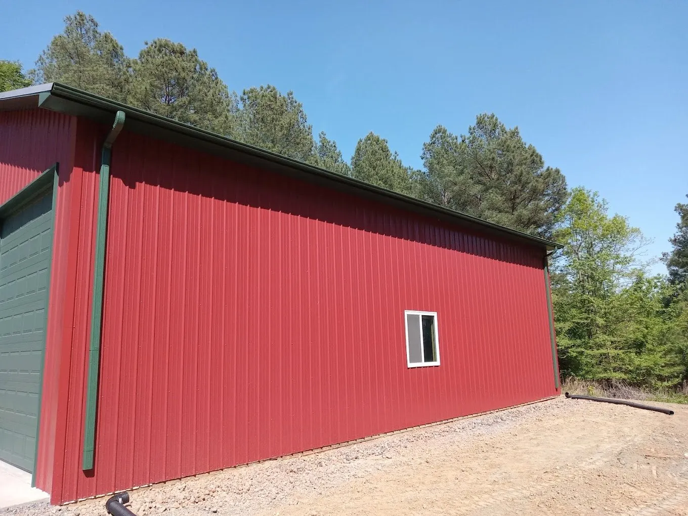 black seamless gutters on a metal building