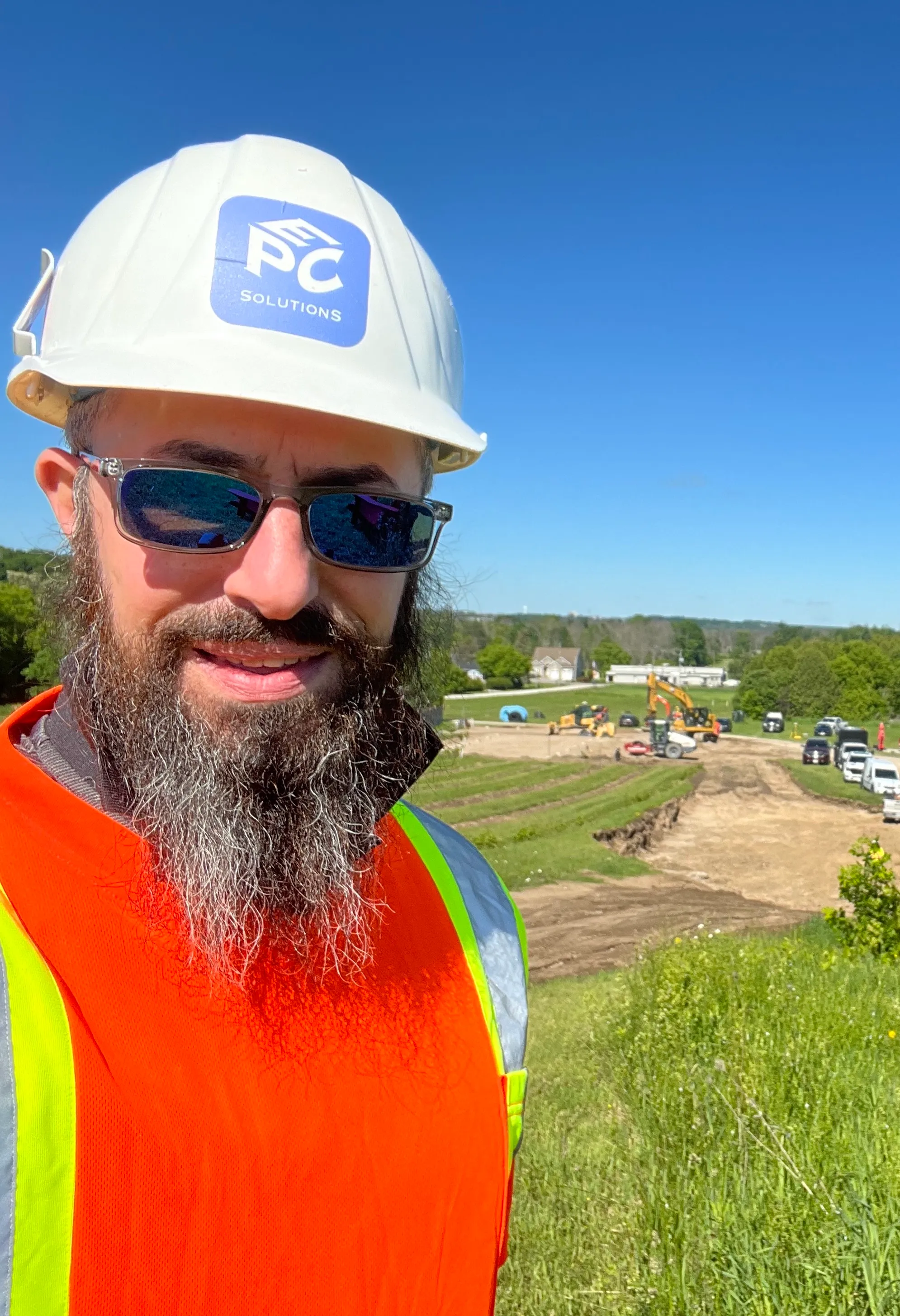 The owner of EPC Solutions, Yosef on a job site wearing a hard hat.