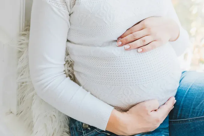 pregnant woman showing off her baby bump