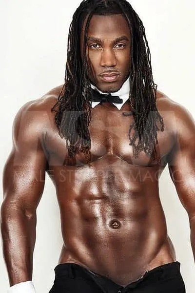 Shirtless Chocolate Male Stripper with Long Braids, Bow Tie, and Cufflinks in Chippendale Style