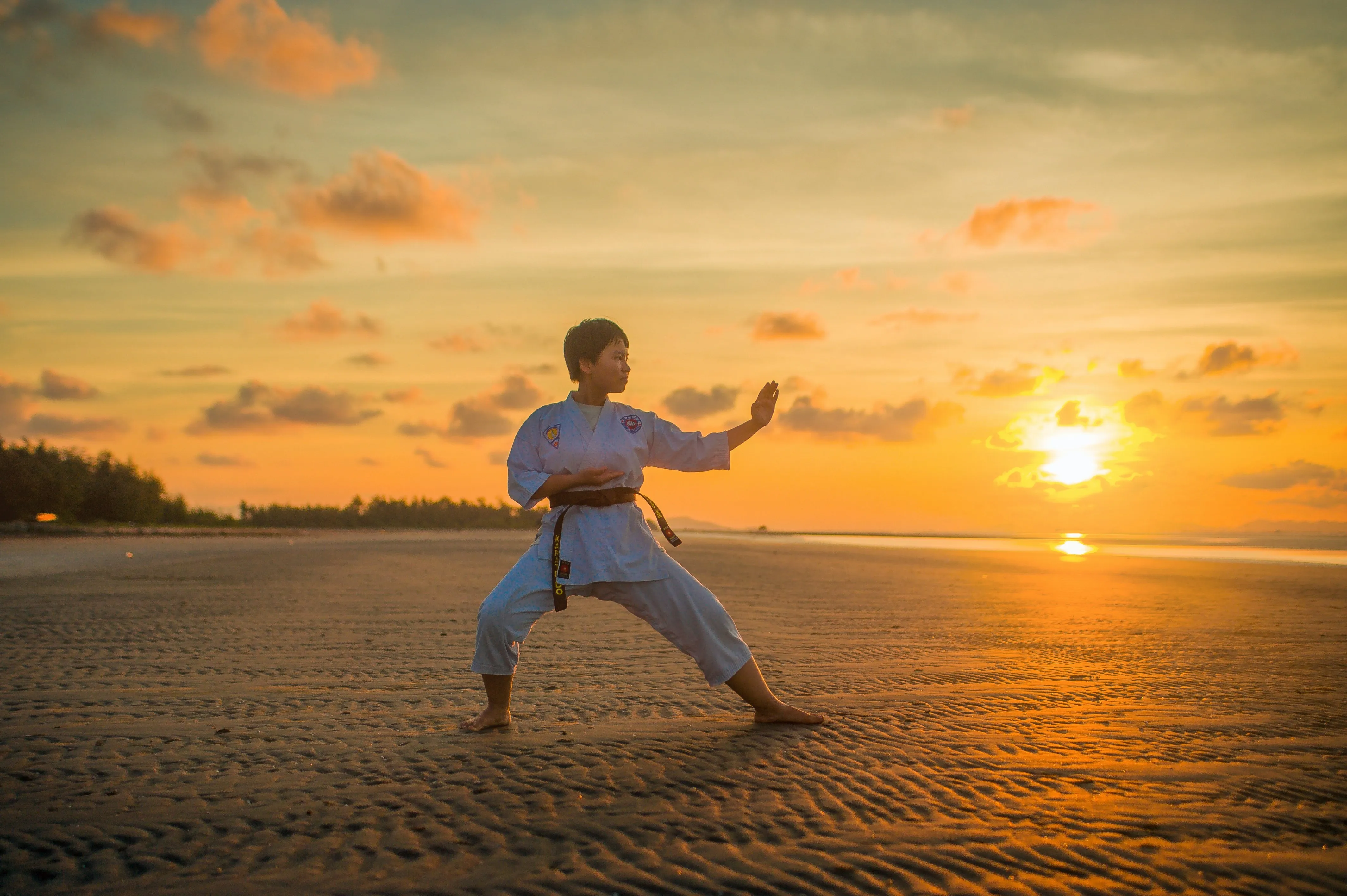 Karate student training on the beach