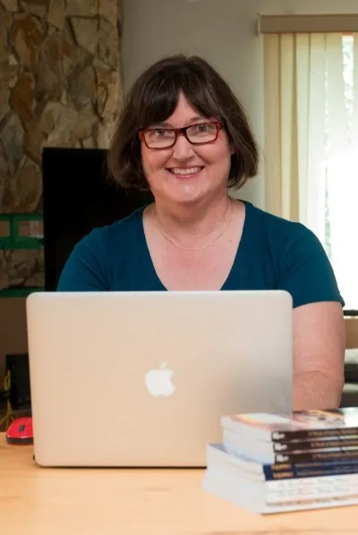 Ruth L. Snyder with laptop and books she has written and published